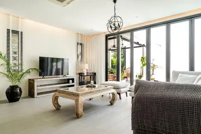 a living room with a couch and a coffee table at Sarah Place Private Tropical Villa in Ban Pak Lak