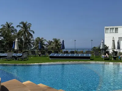 a swimming pool with chairs and umbrellas at a resort at Convenient apartment at Karon Butterfly by Lofty in Karon Beach