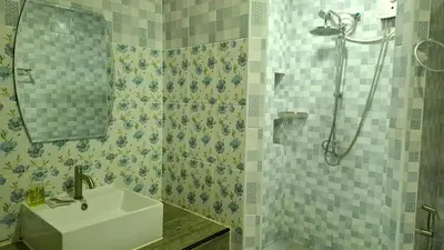 a bathroom with a sink and a shower at Gentle Guesthouse in Patong Beach