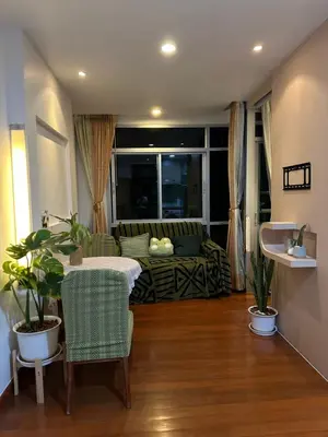 a living room with a table and a couch at Cozy Condo with full kitchen Patong in Patong Beach
