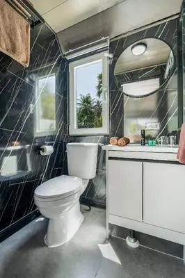 a bathroom with a toilet and a sink at Beachside Apple House Pool & Terrace in Bangtao in Ban Lum Fuang