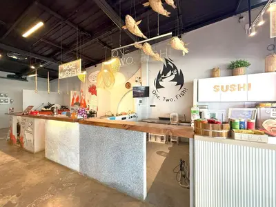 a sushi restaurant with a counter in a room at Apple House by the Sea, Bangtao Area in Ban Lum Fuang