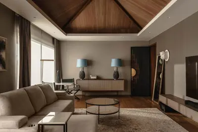 a living room with a couch and a table at Luxury Botanica Villa in Ban Phru Champa