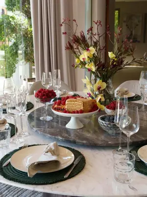 a table with a table set with food and wine glasses at Luxury Botanica Villa in Ban Phru Champa