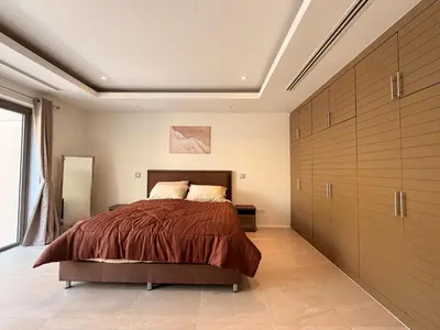 a bedroom with a large bed and wooden cabinets at The Residence Resort Pool Villa 2 Bedrooms and 2 Bathrooms in Ban Thalat Choeng Thale