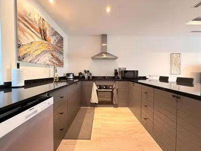 a kitchen with a stove top oven next to a counter at The Residence Resort Pool Villa 2 Bedrooms and 2 Bathrooms in Ban Thalat Choeng Thale