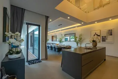 a living room with a kitchen and dining room at Dara Villas - Rawai in Rawai Beach