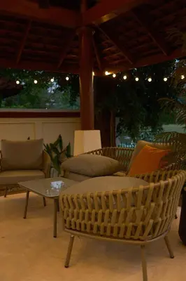 a living room with a wicker chair and a table at Bursuai - Lake view family pool Laguna Village in Ban Thalat Choeng Thale
