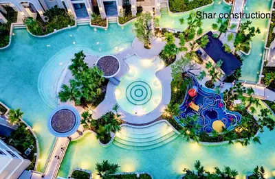 an overhead view of a swimming pool at a resort at title legendary in Bang Tao Beach