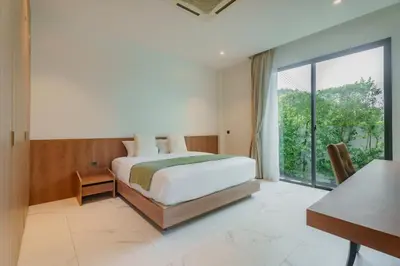 a bedroom with a bed and a large window at Niva Villa - Modern & Lake View near Phuket town in Ban Bang Khu