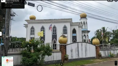 a white building with gold spheres on top of it at Parin House Homestay - Koh Yao Noi in Ko Yao Noi