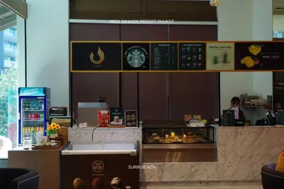 a restaurant with a counter with a person in the background at Suite With Sea View By Mida Grande Resort in Ban Lum Fuang