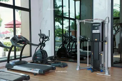 a gym with several treadmills and elliptical machines at Suite With Sea View By Mida Grande Resort in Ban Lum Fuang