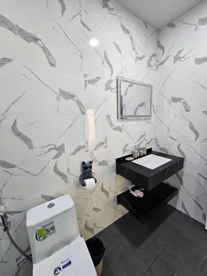 a bathroom with a black and white marble wall at Rawai 4 Bedrooms Private Pool Villa in Rawai Beach