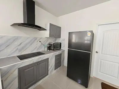 a kitchen with a black refrigerator and a sink at Rawai 4 Bedrooms Private Pool Villa in Rawai Beach