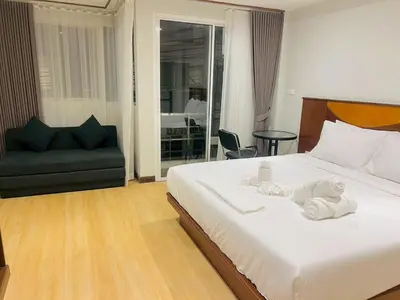 a bedroom with a bed with towels on it at One Houses in Patong Beach