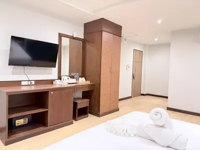 a living room with a television and a bed at One Houses in Patong Beach