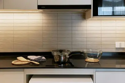 a kitchen with a counter top with two bowls on it at Brand New 2-BR apartment, only 7 min to the beach! in Bang Tao Beach