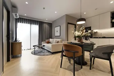 a living room with a couch and a table with chairs at Bangtao The Title Legendary by Phuket Sabay Rent I302 in Bang Tao Beach