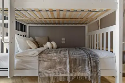 a bedroom with a white bunk bed with a wooden ceiling at Bangtao The Title Legendary by Phuket Sabay Rent I302 in Bang Tao Beach