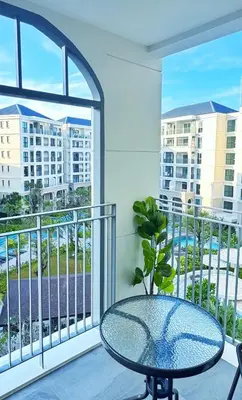 a balcony with a table and a view of a city at Bright Modern Phuket Home Title Legendary Bangtao in Bang Tao Beach