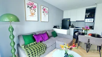 a living room with a couch and a kitchen at Bright Modern Phuket Home Title Legendary Bangtao in Bang Tao Beach