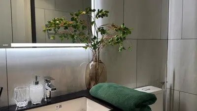 a bathroom with a sink and a vase with a plant at Bright Modern Phuket Home Title Legendary Bangtao in Bang Tao Beach