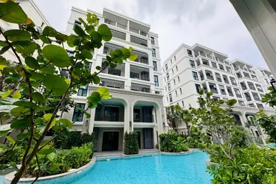 an apartment complex with a swimming pool in front of buildings at Title Legendary suite pool view E301 in Phuket