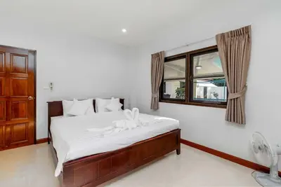 a bedroom with a white bed with a window at V278 Quiet Poolside 3BR Villa for Relaxed Stays in Ban Bang Chak