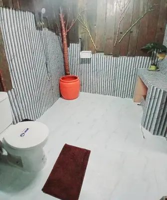 a bathroom with a toilet and a tree in it at Kalaland camp tant Patong in Patong Beach
