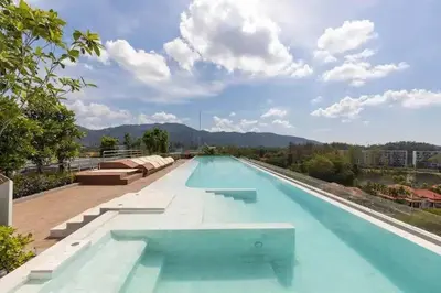 a large swimming pool with blue water on a building at Apartments in the center of Laguna in Laguna Phuket