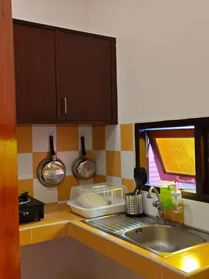a kitchen counter with a sink and a window at Tangerine Villa Patong in Patong Beach