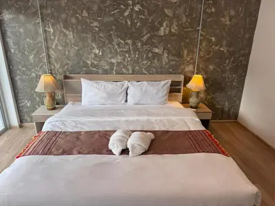 a bedroom with a bed with two towels on it at Global Hills View in Patong Beach