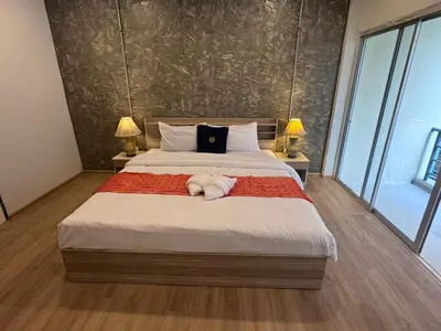 a bedroom with a large bed with two lamps at Global Hills View in Patong Beach