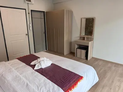 a bedroom with a bed with a towel on it at Global Hills View in Patong Beach