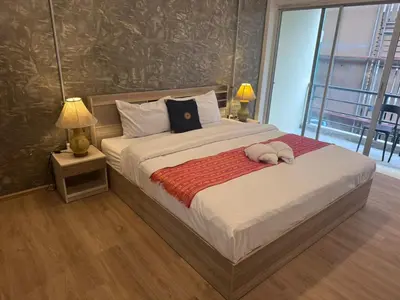 a bedroom with a bed with a stuffed animal on it at Global Hills View in Patong Beach