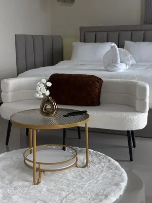 a bedroom with a bed and a table and a couch at Luxury villa with sea view, pool and maid in Patong Beach