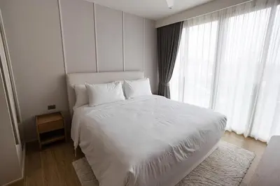a white bed in a room with windows at Premium 1BR Laguna, 200m to the Beach in Bang Tao in Bang Tao Beach