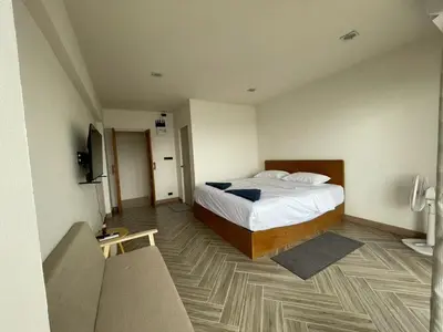 a hotel room with a bed and a staircase at Acacia Phuket in Nai Harn Beach