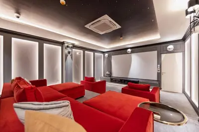 a living room with a red couch and red chairs at Delos 1BR Suite — The Title Legendary BangTao in Bang Tao Beach
