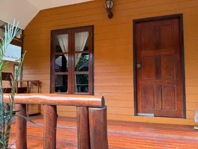 a wooden house with a door and a porch at Ja Mia's Bungalow at Pasai Beach in Ko Yao Noi