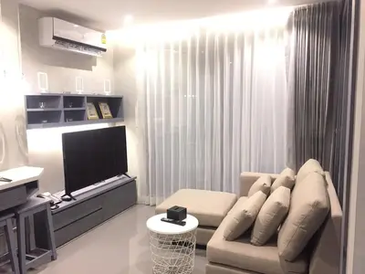 a living room with a couch and a flat screen tv at luxury apartment at Kamala in Kamala Beach