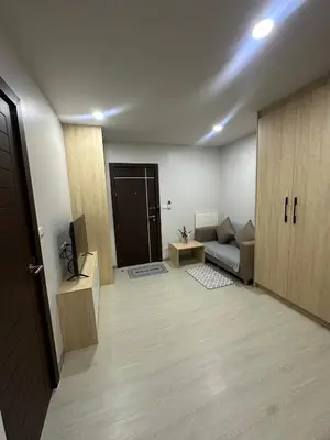 a living room with a couch and a television at Апартаменты VIP Great Hill in Nai Yang Beach