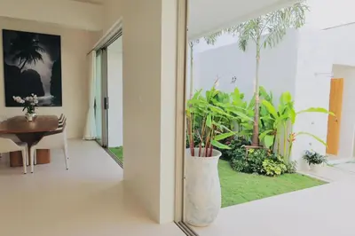 a room with a table and a large vase with plants at The Coco Villa by Escape Villas - NEW tropical 2BR Pool Villa in Ban Riang