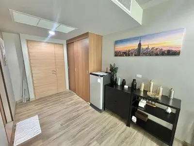 a living room with a refrigerator and a table at Karon Beach Forest View in Ban Karon