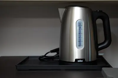 a tea kettle is sitting on a stove at Bellevue Lagoon by My Home Phuket in Laguna Phuket