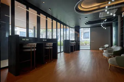 a lobby with a bar with stools and chairs at Bellevue Lagoon by My Home Phuket in Laguna Phuket