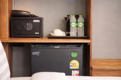 a microwave and a radio sitting on a shelf at The Homey Boutique Rawai in Ban Nong Chaeng