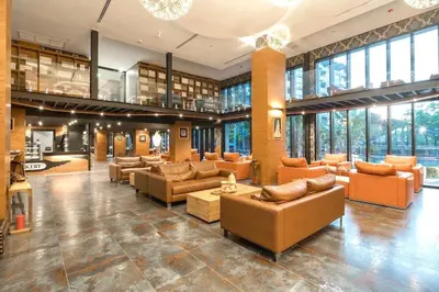 a large lobby with couches and tables and windows at Citygate condo at Kamala Beach in Kamala Beach