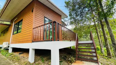 a house with a staircase leading up to a cabin at บ้านสกุลลี-House of Lee in Ban Huai Sai